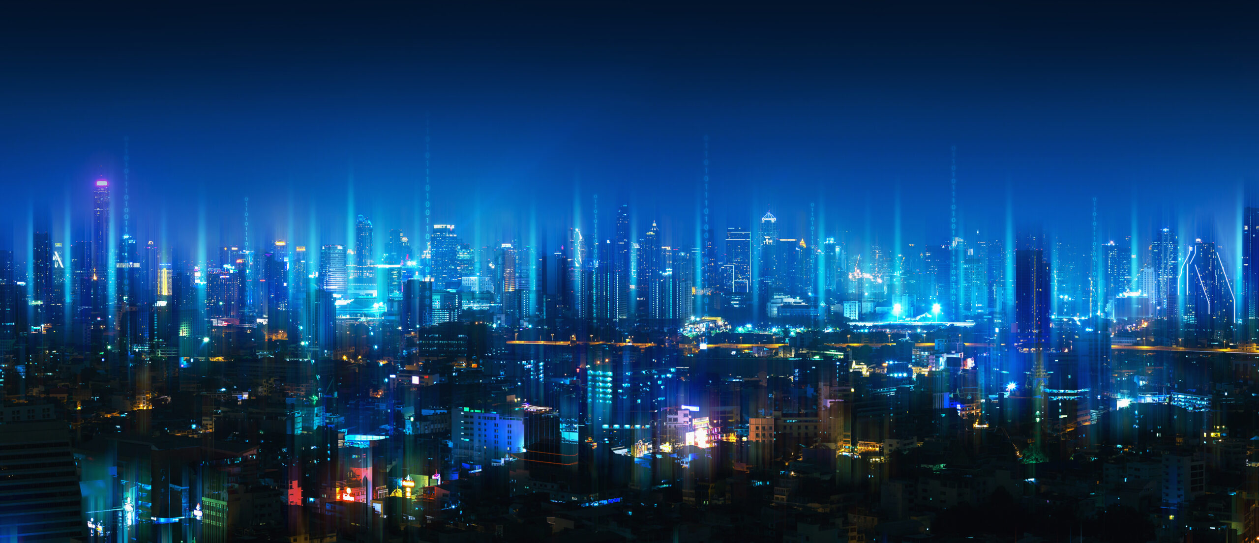 This image shows lights raising above a city to depict connectivity on a large scale.
