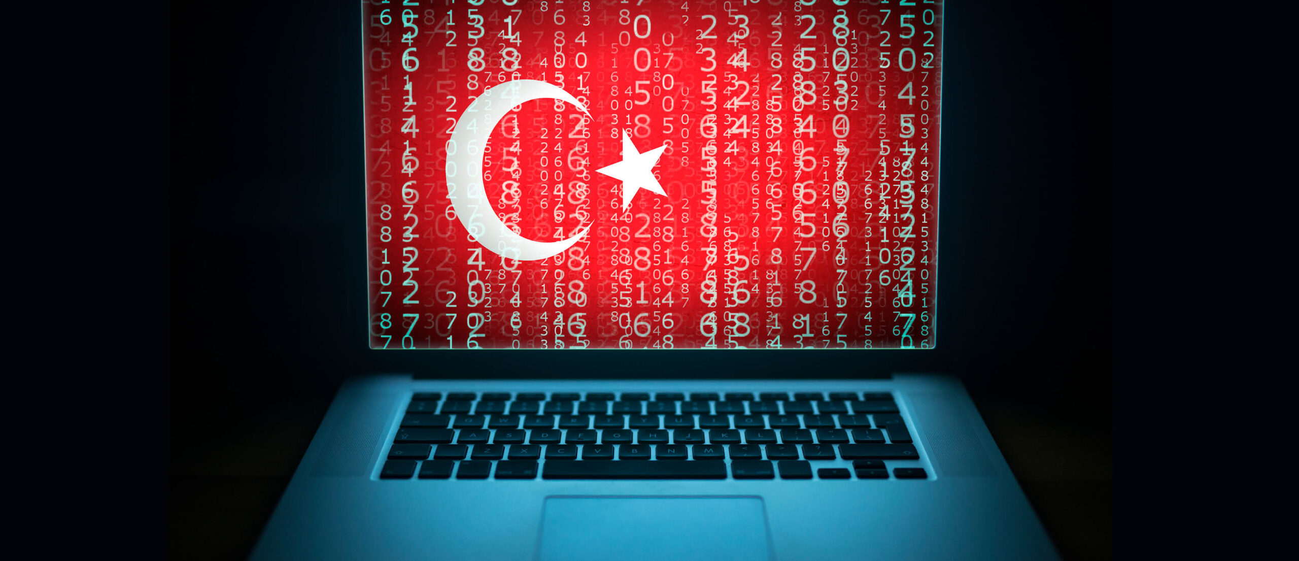 This image depicts a laptop that shows the Turkish flag with an overlay of code.